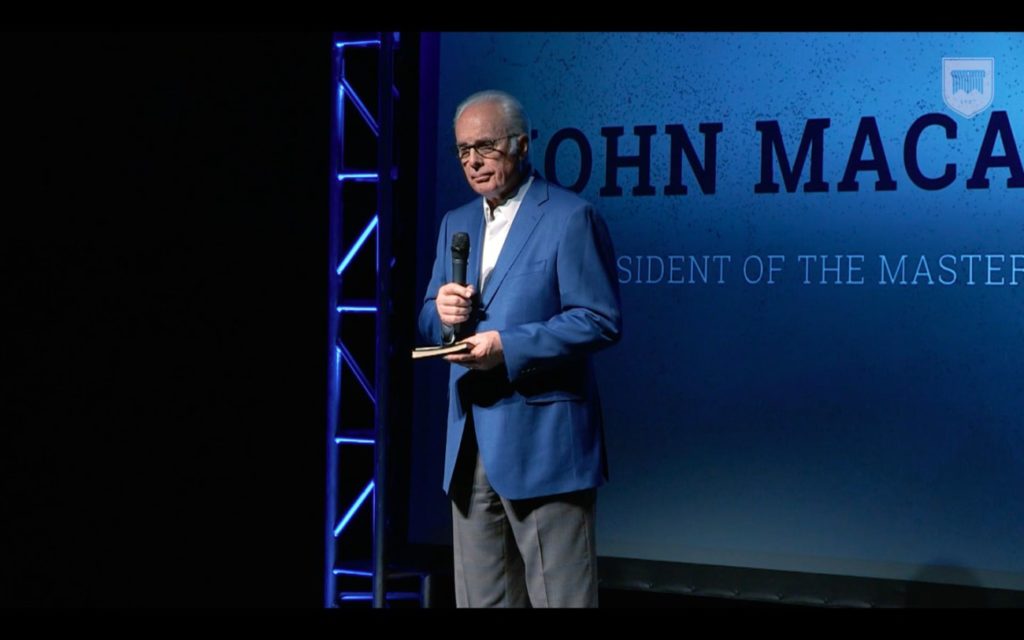 John MacArthur image speaking at conference on self importance and making a difference