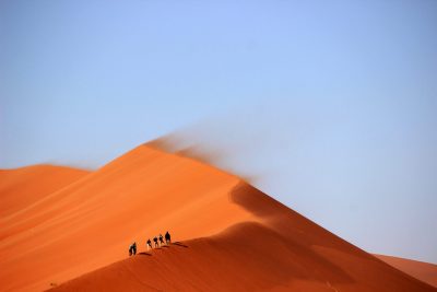 men walking in desert