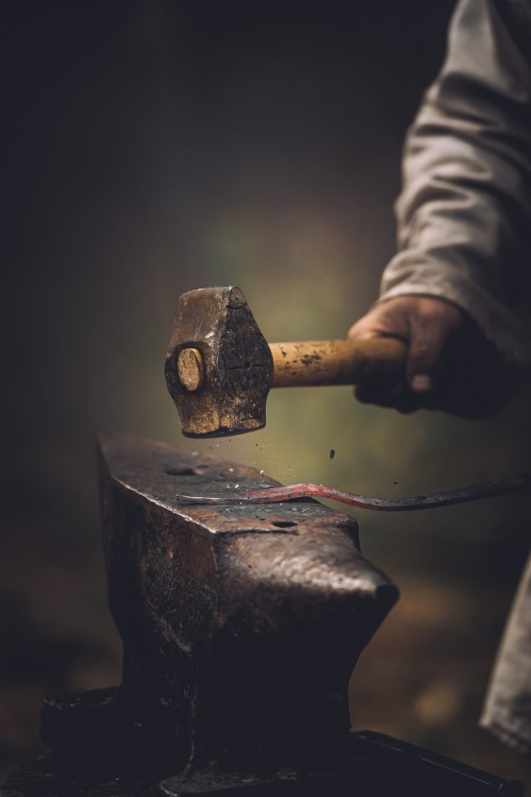 person holding gray metal tool