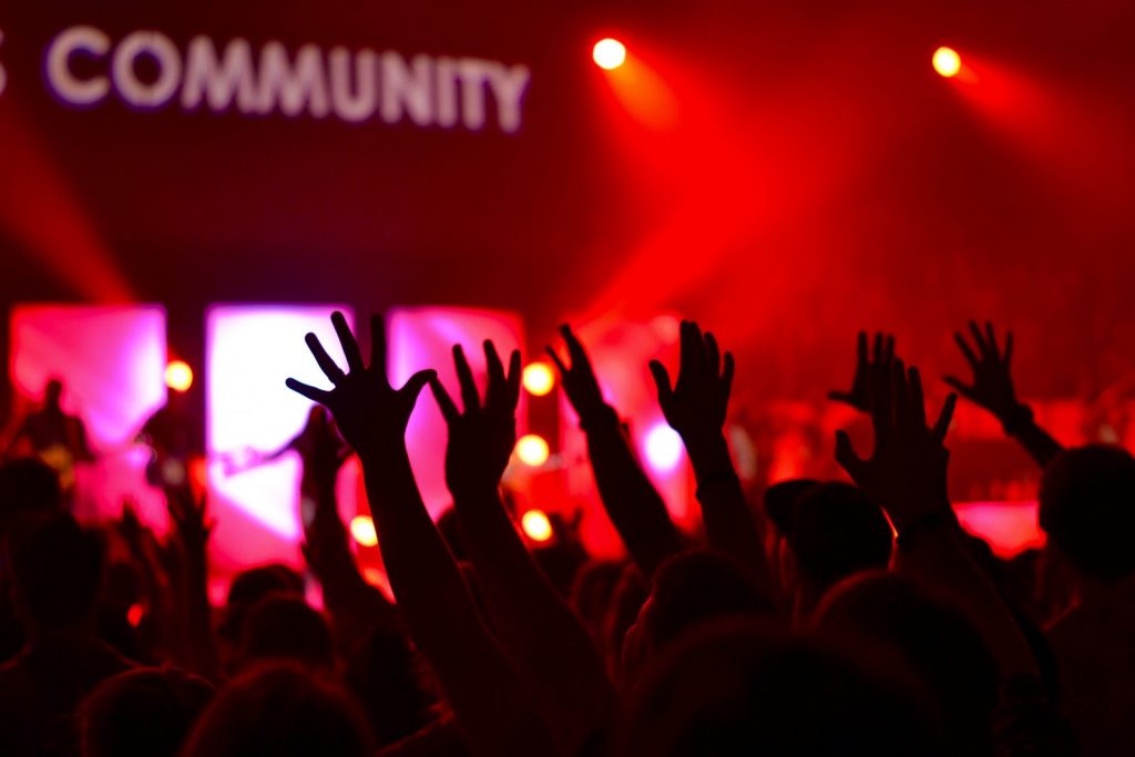 church community worship light show hands lifted